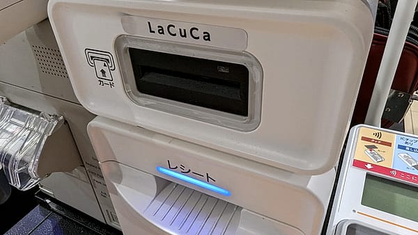 A card payment terminal mounted at a counter with its screen facing the customer