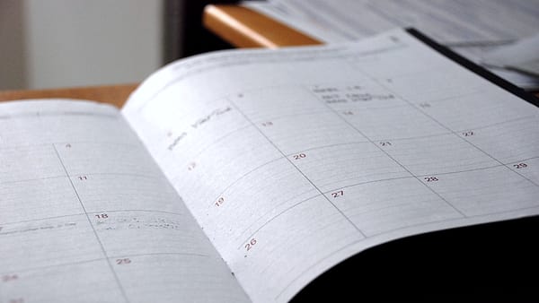 A blank monthly wall planner laid flat, its grid of numbered squares running across the page