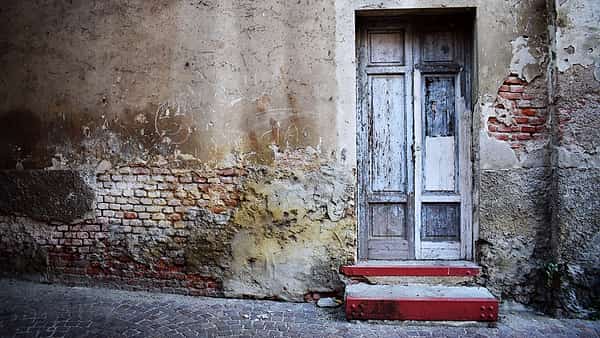 A closed residential front door photographed straight on in flat daylight