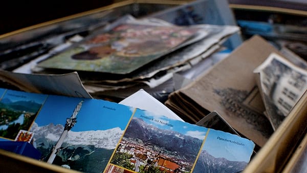 A box of loose papers and documents standing open on a flat surface