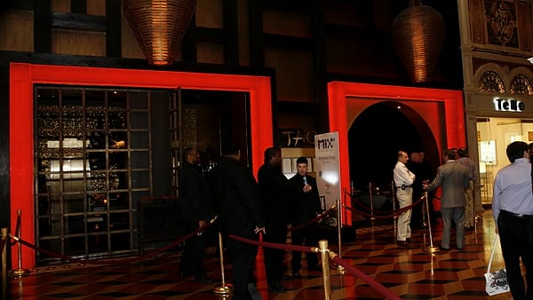 Retractable queue barriers set out across an entrance with nobody waiting