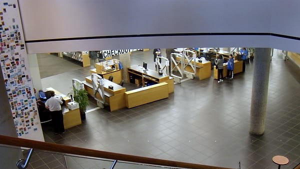 A library service counter with its returns desk and shelving standing behind it