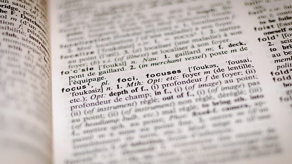 A dictionary page in close-up with one printed entry and its definition in focus