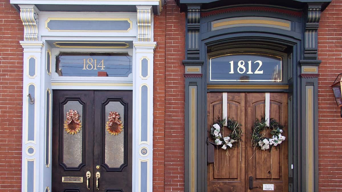 Two front doors side by side on the frontage of a pair of adjoining houses