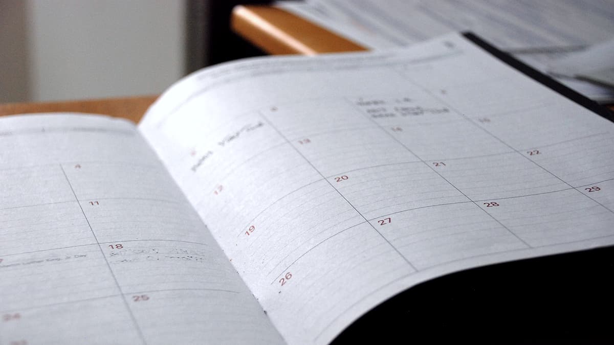 A blank monthly wall planner laid flat, its grid of numbered squares running across the page