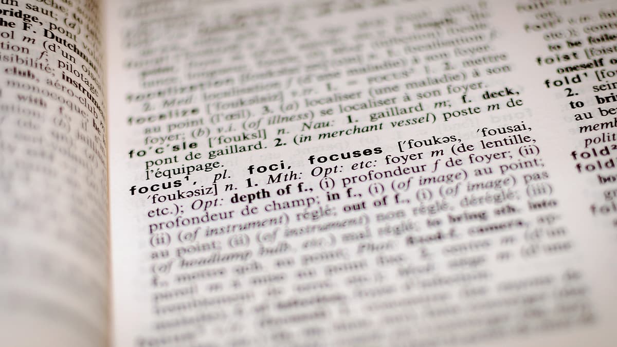 A dictionary page in close-up with one printed entry and its definition in focus